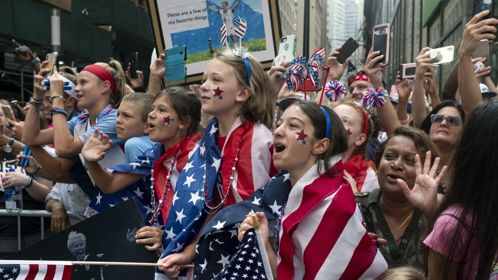 Fans celebrates as members of the the U.S. women's soccer team pass by during a ticker tape parade along the Canyon of Heroes, Wednesday, July 10, 2019, in New York. The U.S. national team beat the Ne