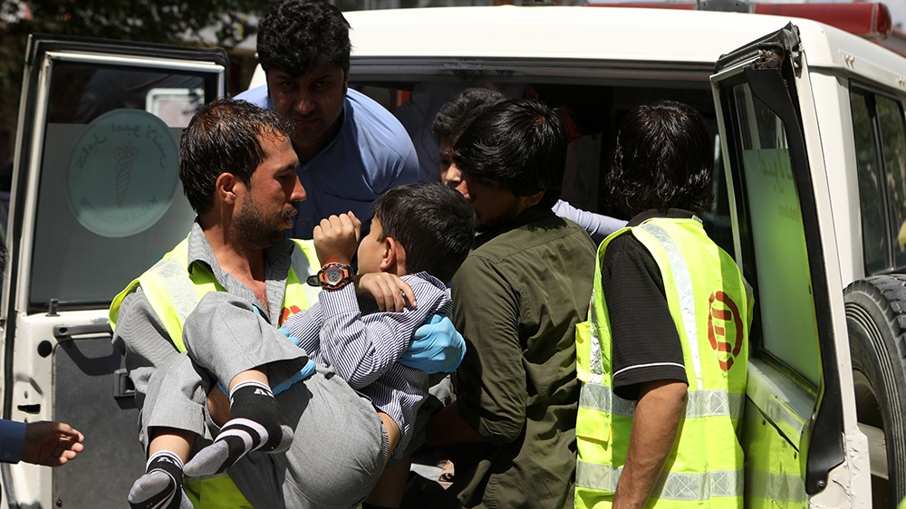 An Afghan health worker carries a wounded school student after a car bomb blast targeted a governmental institution in downtown Kabul, Afghanistan, 01 July 2019. According to reports, dozens of people
