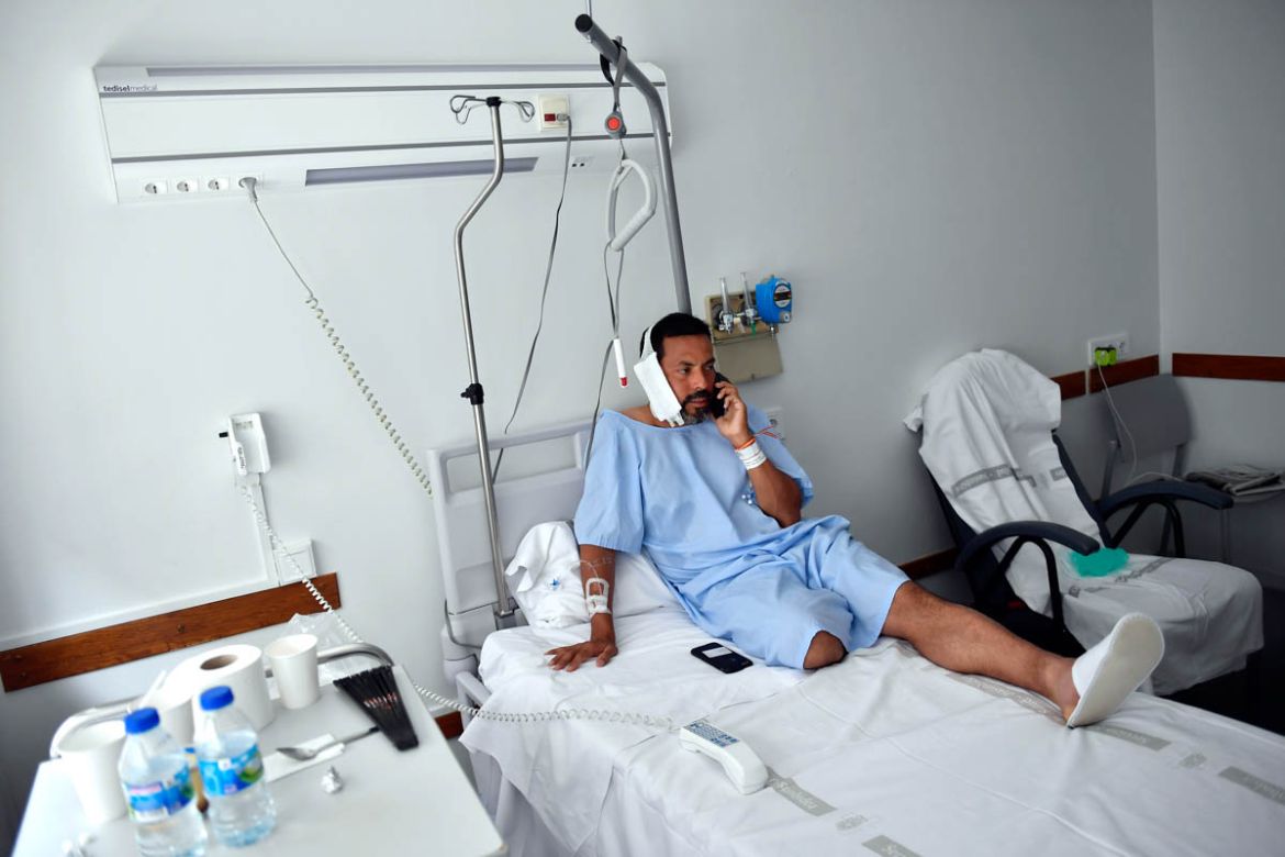 Jaime Alvarez from Santa Clara County, California, sits in a hospital in Pamplona, northern Spain, Monday, July 8, 2019 after being gored by a bull Sunday at the San Fermin Festival. Alvarez, a 46-yea