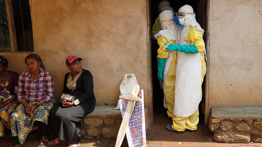 Healthcare workers enter a house where a baby suspected of dying of Ebola is, during the funeral in Beni, North Kivu Province of Democratic Republic of Congo, December 18, 2018.   REUTERS/Goran Tomase
