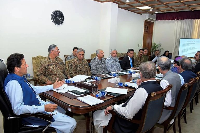 In this handout picture taken and released by Prime Minister Office (PMO) on August 7, 2019 Pakistan''s Prime Minister Imran Khan (L) chairs a National Security Committee meeting along with armed force
