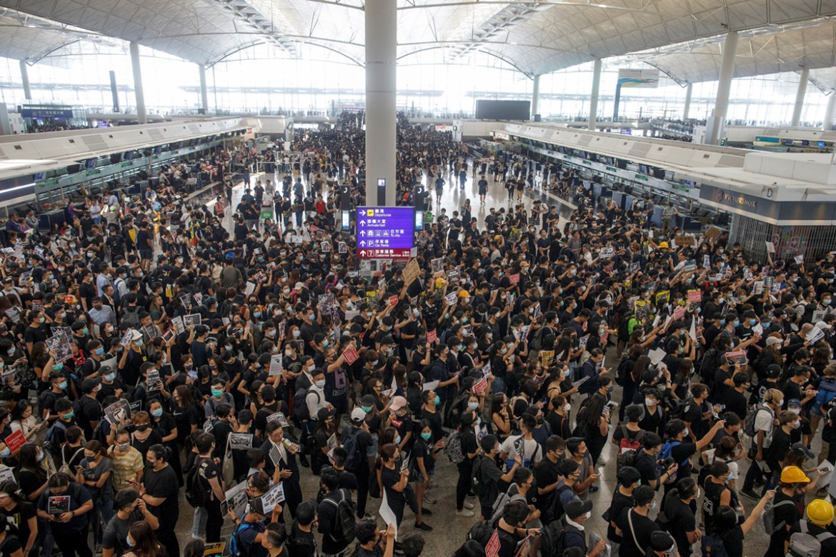 Anti-extradition bill protesters rally at the departure hall of Hong Kong airport in Hong Kong, China August 12, 2019. REUTERS/Thomas Peter