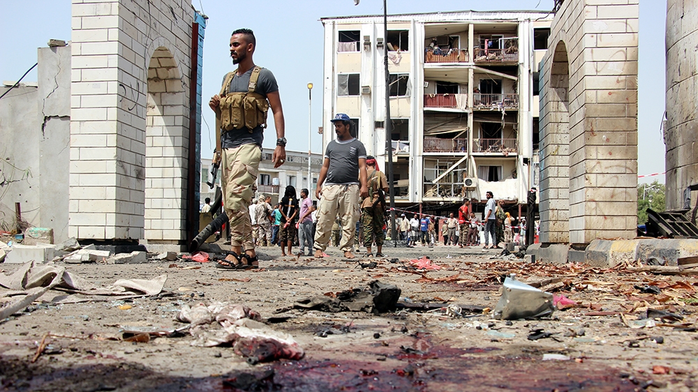 Yemeni soldiers inspect the site of a car bomb attack that targeted a police station in the southern port city of Aden, Yemen, 01 August 2019. According to reports, at least 40 security personnel and 