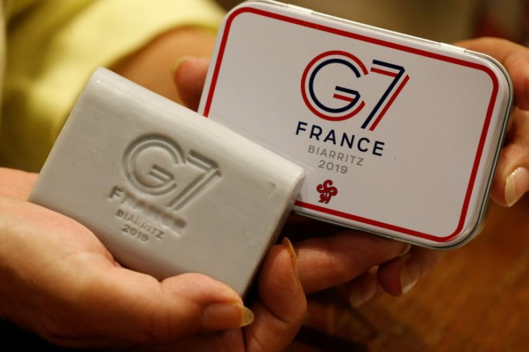 A woman holds a soap souvenir of G7 summit in a shop ahead of the G7 summit in Biarritz