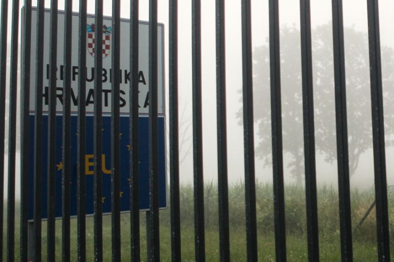 A border sign behind a section of the fence on the border between Croatia and Bosnia near the village of Maljevac, Croatia, Tuesday, June 11, 2019.
