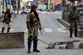 Indian paramilitary forces stand vigil during a lockdown in old city Srinagar on August 8, Thousands of Indian forces personals were patrolling streets amid a clampdown after Indian government abrogat