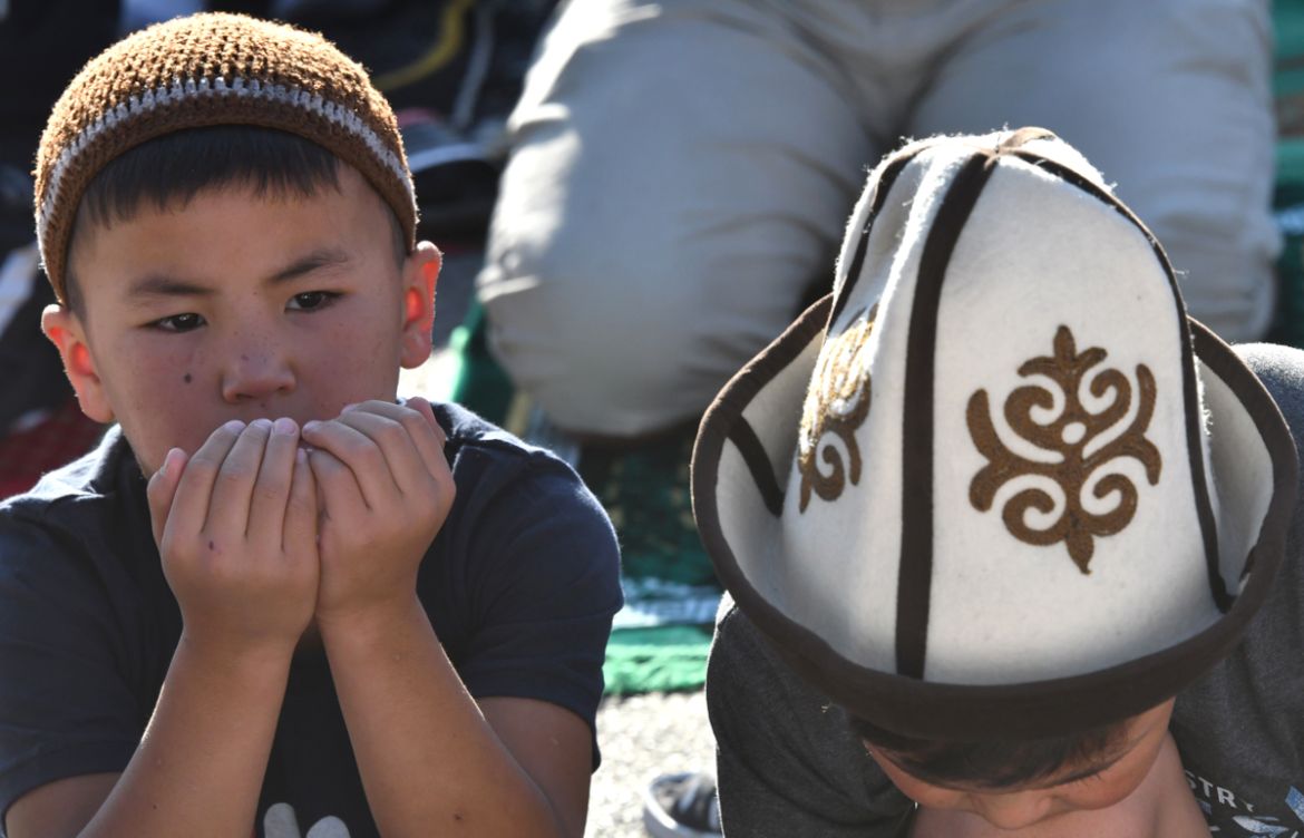 Young Kyrgyz Muslims pray on the first day of the Eid al-Adha (Feast of Sacrifice) in central Bishkek on August 11, 2019. - Muslims across the world are celebrating the annual festival of Eid al-Adha,