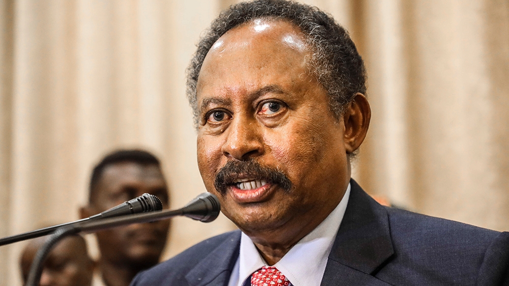 FILE - In this Wednesday, Aug. 21, 2019 file photo, Sudan's new Prime Minister Abdalla Hamdok speaks during a press conference in Khartoum, Sudan. Hamdok said in the interview that ending his country'