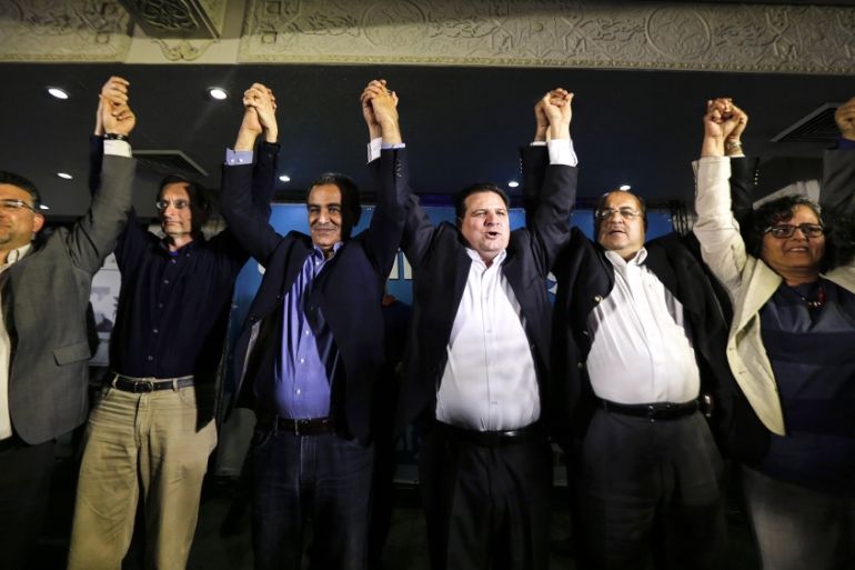 Ayman Odeh (3rd R), head of the Joint Arab List, reacts with members of the party after exit poll results in Nazareth March 17, 2015. Prime Minister Benjamin Netanyahu closed a gap with center-left ri