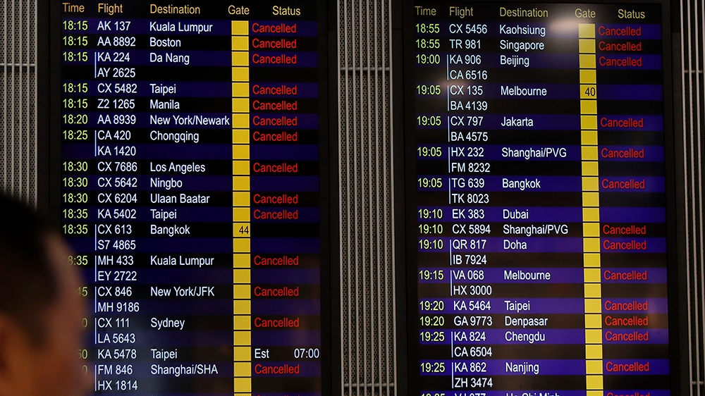 A man looks at the flight information board shows outbound flights was cancel at the Hong Kong International airport, Monday, Aug. 12, 2019. One of the world’s busiest airports cancelled all remaining