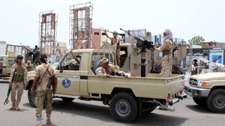 Members of UAE-backed southern Yemeni separatist forces patrol a road during clashes with government forces in Aden, Yemen