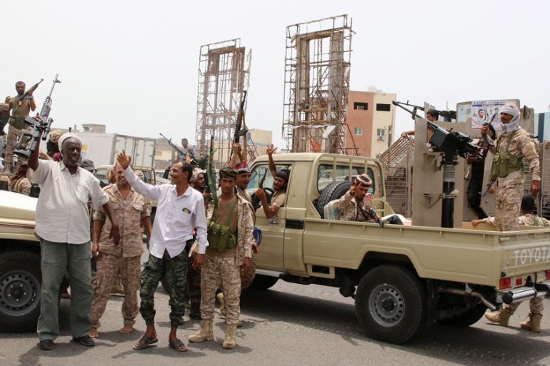 Members of UAE-backed southern Yemeni separatist forces shout slogans as they patrol a road during clashes with government forces in Aden
