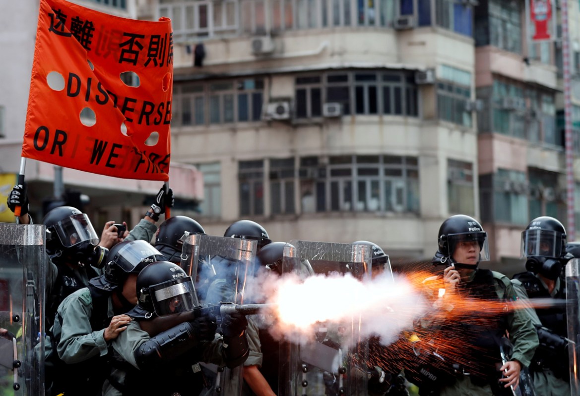 Police officers fire tear gas as anti-extradition bill protesters demonstrate in Sham Shui Po neighbourhood in Hong Kong, China, August 11, 2019. REUTERS/Tyrone Siu