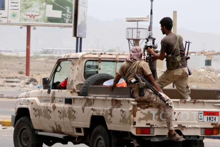Members of UAE-backed southern Yemeni separatist forces patrol a road during clashes with government forces in Aden