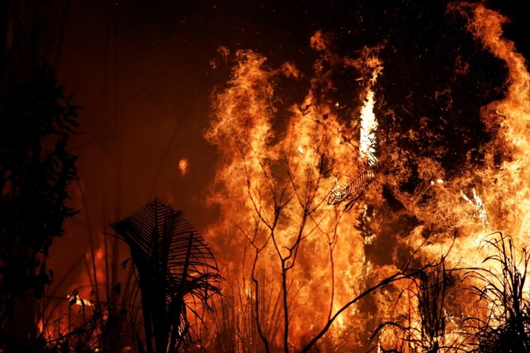 A fire burns a tract of Amazon jungle as it is cleared by loggers and farmers near Altamira, Brazil, August 27, 2019