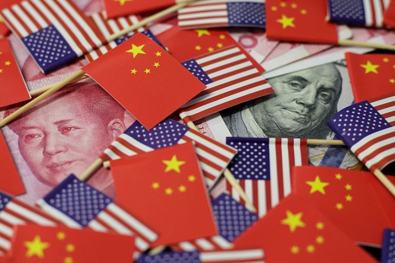 US flag, China flag w/currencies/Reuters illustration