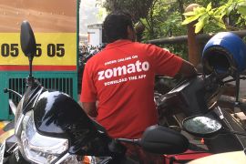 In this file photo taken on December 24, 2018 an Indian delivery man working with the food delivery app Zomato sits on his bike in Mumbai. An Indian food service has sparked a national debate and set