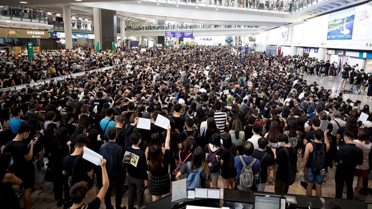 Protesters demonstrate at the airport in Hong Kong, Monday, Aug. 12, 2019. Several thousand people gathered on Monday for a fourth day of protest at Hong Kong''s busy international airport. (AP Photo/V