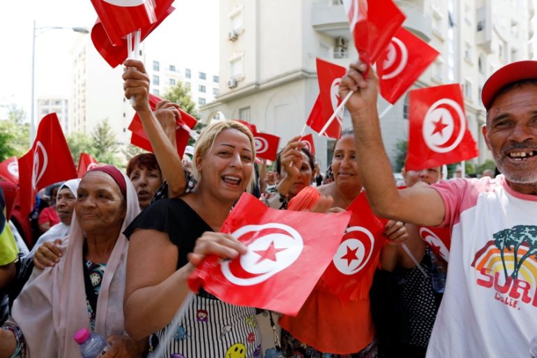 Supporters react after Tunisian Prime Minister Youssef Chahed submitted his candidacy for the presidential elections, in Tunis