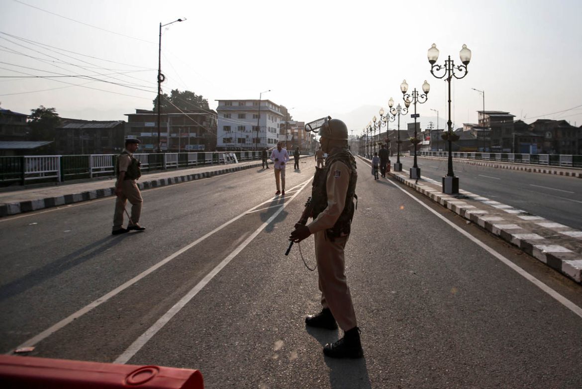 Indian security personnel stand guard on a deserted road during restrictions in Srinagar, August 5, 2019. REUTERS/Danish IsmailIndian security personnel stand guard on a deserted road during restricti