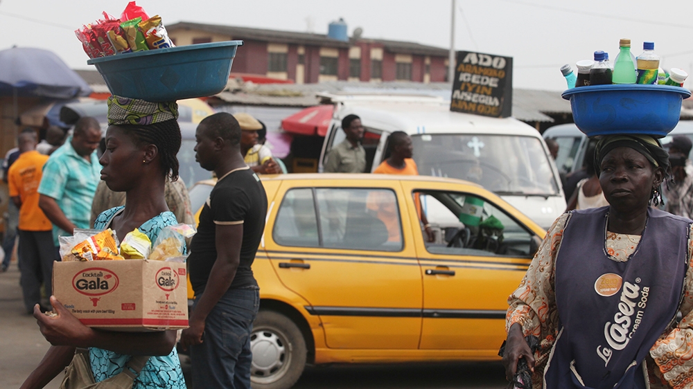 Women sells snacks  and water at Ojota bus terminal in Lagos, Nigeria, Friday, Nov. 25, 2011. (AP Photo/Sunday Alamba)