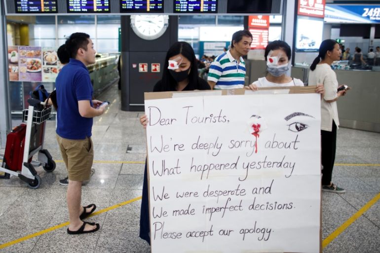 Anti-government demonstrators apologize for yesterday''s clashes with police at the airport in Hong Kong