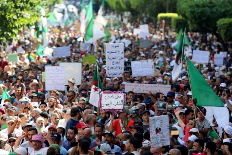 Demonstrators march as they shout slogans during an anti-government protest in Algiers
