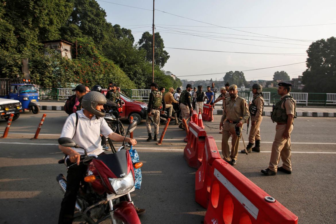 Indian security personnel stop people during restrictions in Srinagar, August 5, 2019. REUTERS/Danish Ismail