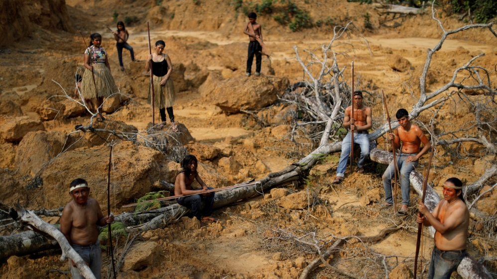 Indigenous people from the Mura tribe show a deforested area in unmarked indigenous lands inside the Amazon rainforest near Humaita, Amazonas State, Brazil August 20, 2019.