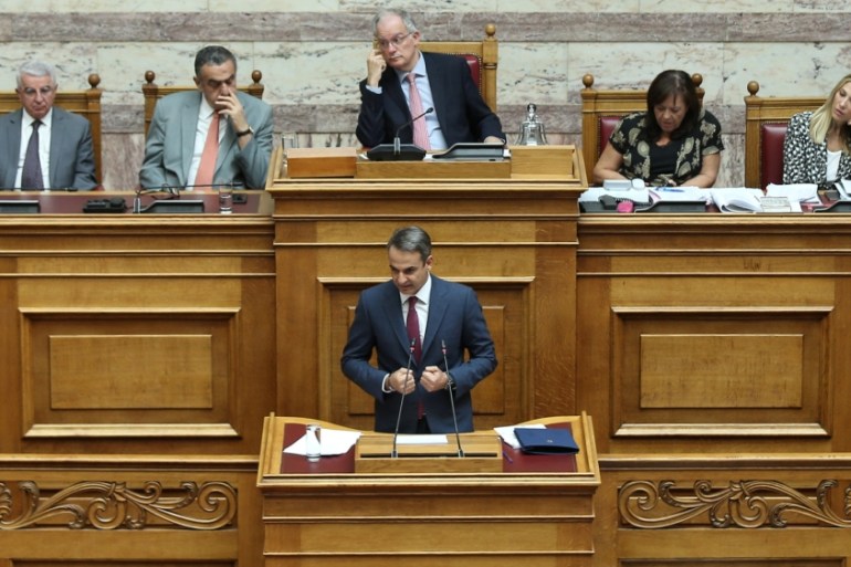 Greek Prime Minister Kyriakos Mitsotakis addresses lawmakers during a parliamentary session before a vote on abolishment of the academic asylum in Athens