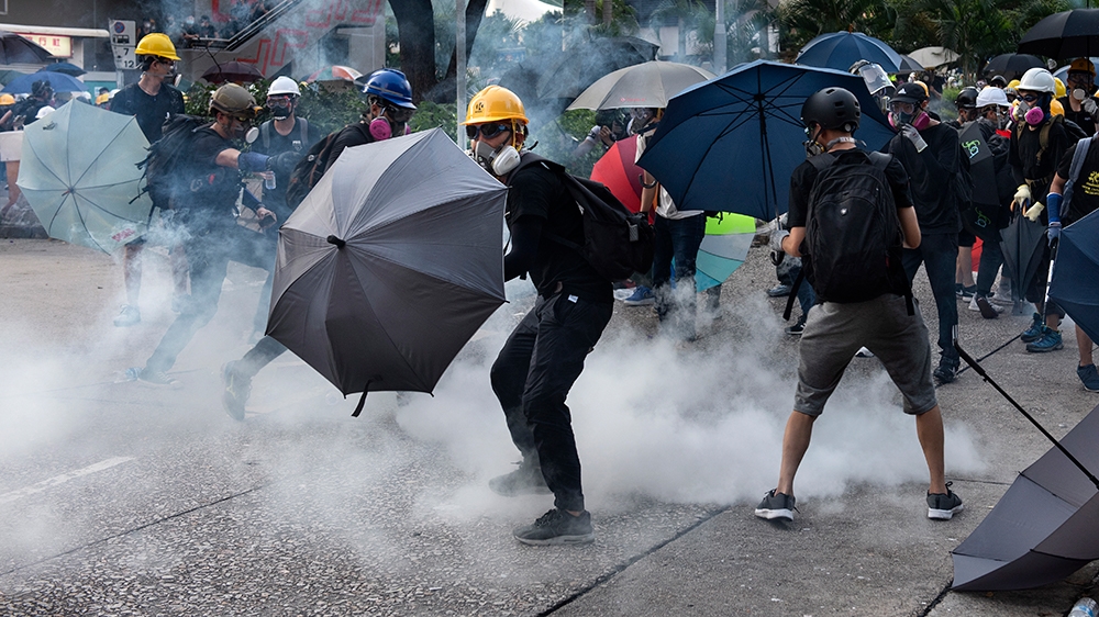 Anti-extradition protesters react after tear gas was fired at them by police during clashes in Wong Tai Shin area in Hong Kong, China, 05 August 2019. Hong Kong is in the midst of a citywide strike fo
