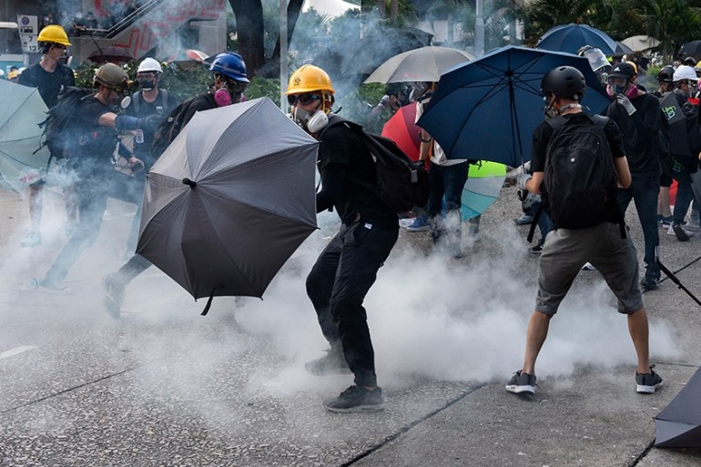 Anti-extradition protesters react after tear gas was fired at them by police during clashes in Wong Tai Shin area in Hong Kong, China, 05 August 2019. Hong Kong is in the midst of a citywide strike fo