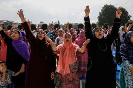 Kashmiri women shout pro-freedom slogans before offering the Eid-al-Adha prayers at a mosque during restrictions after the scrapping of the special constitutional status for Kashmir by the Indian gove