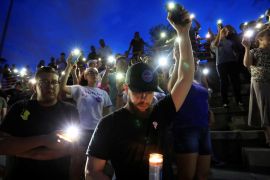 Mourners take part in a vigil at El Paso High School after a mass shooting at a Walmart store in El Paso