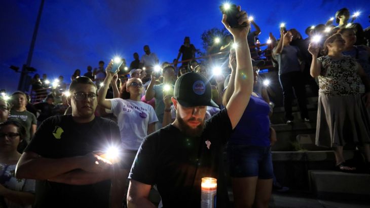 Mourners take part in a vigil at El Paso High School after a mass shooting at a Walmart store in El Paso