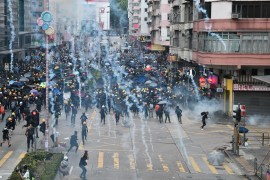 Pro-Democracy protesters throw back tear gas fired by the police during a demonstratrion against the controversial extradition bill in Sham Shui Po district in Hong Kong on August 11, 2019. - Thousand