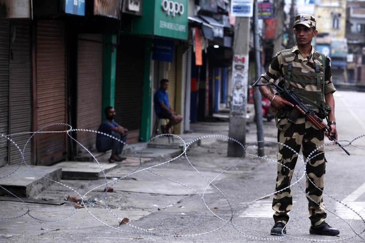 A security personnel stands guard on a street in Jammu on August 6, 2019. Washington on August 4 urged respect for rights and called for the maintenance of peace along the de facto border in Kashmir a
