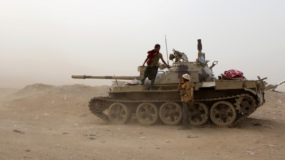 Members of UAE-backed southern Yemeni separatist forces stand by a tank during clashes with government forces in Aden