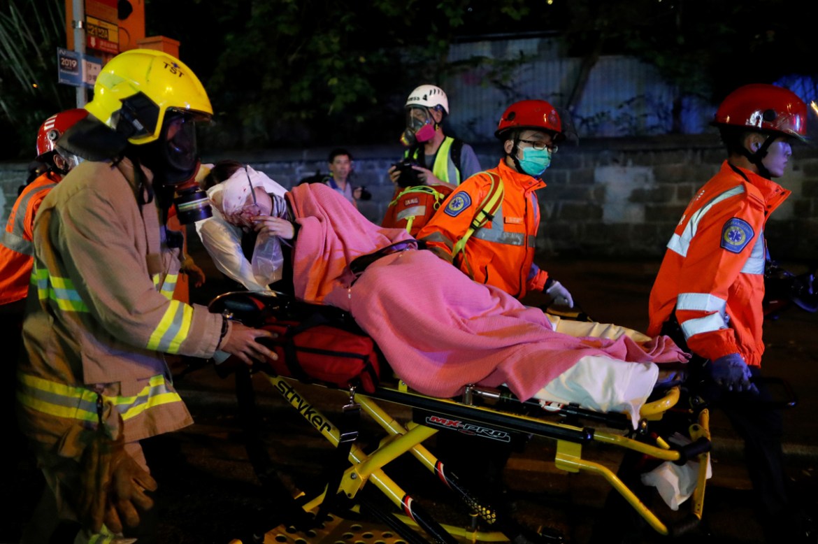 An injured anti-extradition bill protester receives medical assistance during a demonstration in Tsim Sha Tsui neighbourhood in Hong Kong, China, August 11, 2019. REUTERS/Issei Kato -