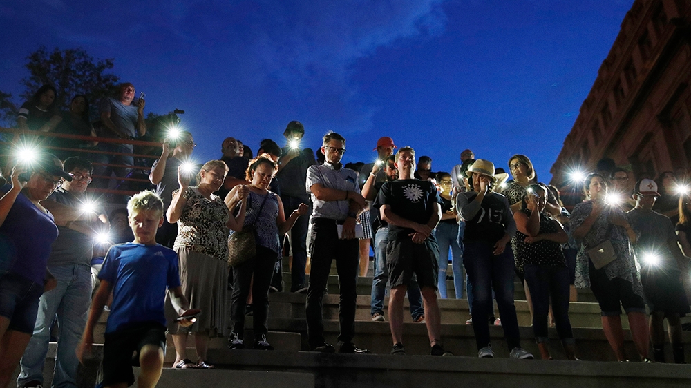 People attend a vigil for victims of the shooting Saturday, Aug. 3, 2019, in El Paso, Texas. (AP Photo/John Locher)