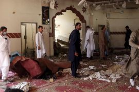Members of a bomb disposal unit survey the site after a blast at a mosque in Kuchlak, in the outskirts of Quetta
