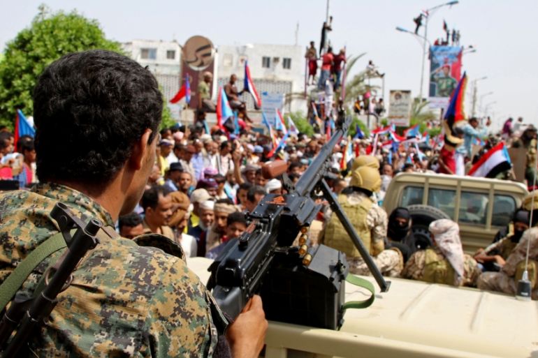 Members of UAE-backed southern Yemeni separatists forces are seen together with their supporters as they march during a rally in southern port city in Aden