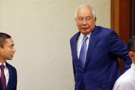 Former Malaysian Prime Minister Najib Razak walks out of a courtroom for a break at Kuala Lumpur High Court in Kuala Lumpur