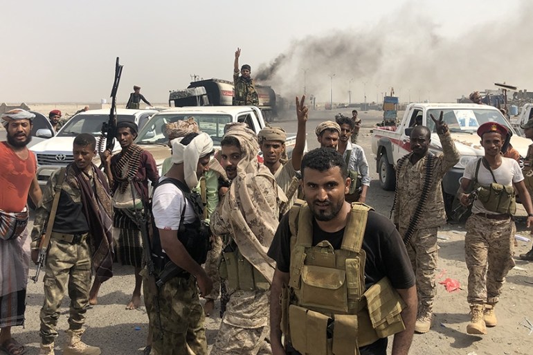 Fighters of the UAE-trained Security Belt Force, dominated by members of the Southern Transitional Council (STC) which seeks independence for south Yemen, flash the V-sign of victory at the al-Alam cr