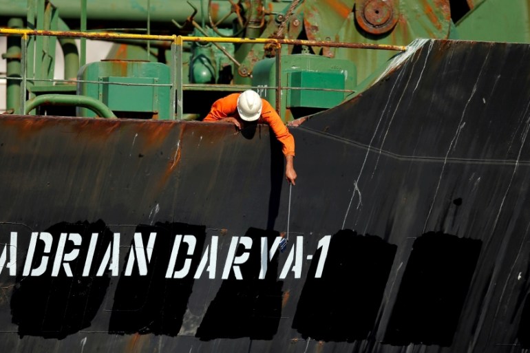A crew member takes pictures with a mobile phone on Iranian oil tanker Adrian Darya 1,