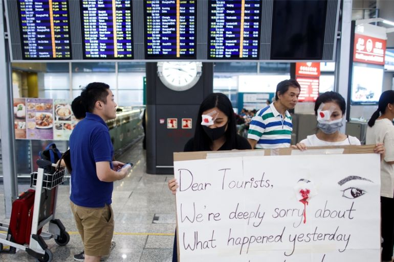 Anti-government demonstrators apologize for yesterday''''s clashes with police at the airport in Hong Kong China August 14, 2019. REUTERS/Thomas Peter