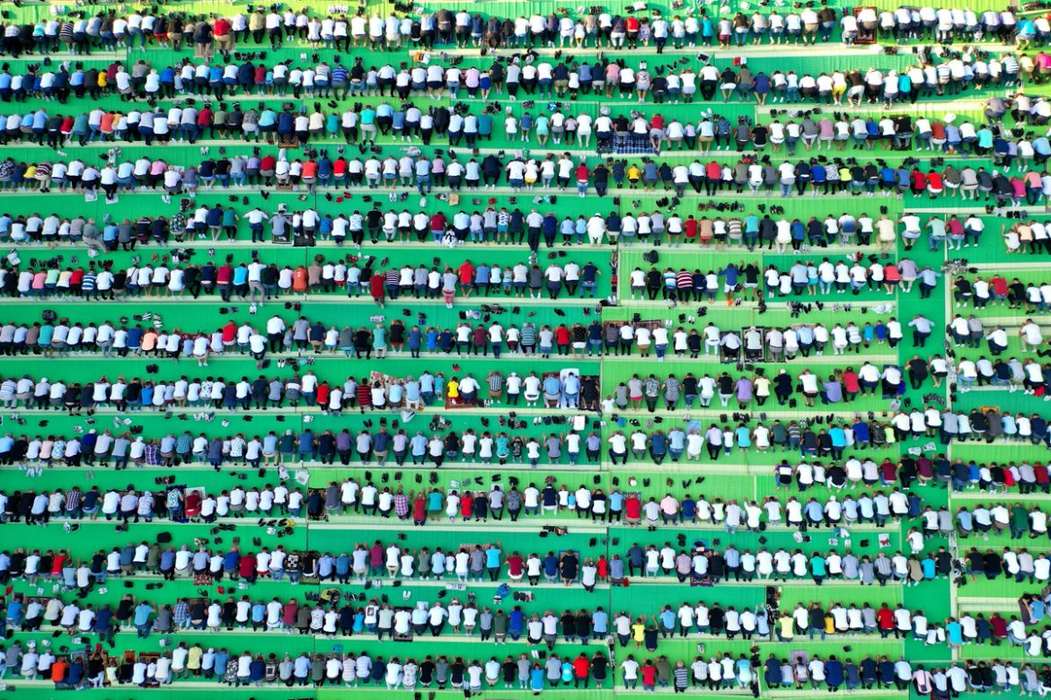 This aerial photo taken on August 11, 2019, shows Albanian Muslims praying at Skenderbej square in Tirana during the Eid al-Adha Festival. - Muslims across the world are celebrating the annual festiva
