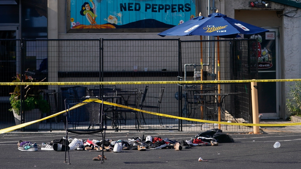 Shoes are piled in the rear of Ned Peppers Bar at the scene after a mass shooting in Dayton