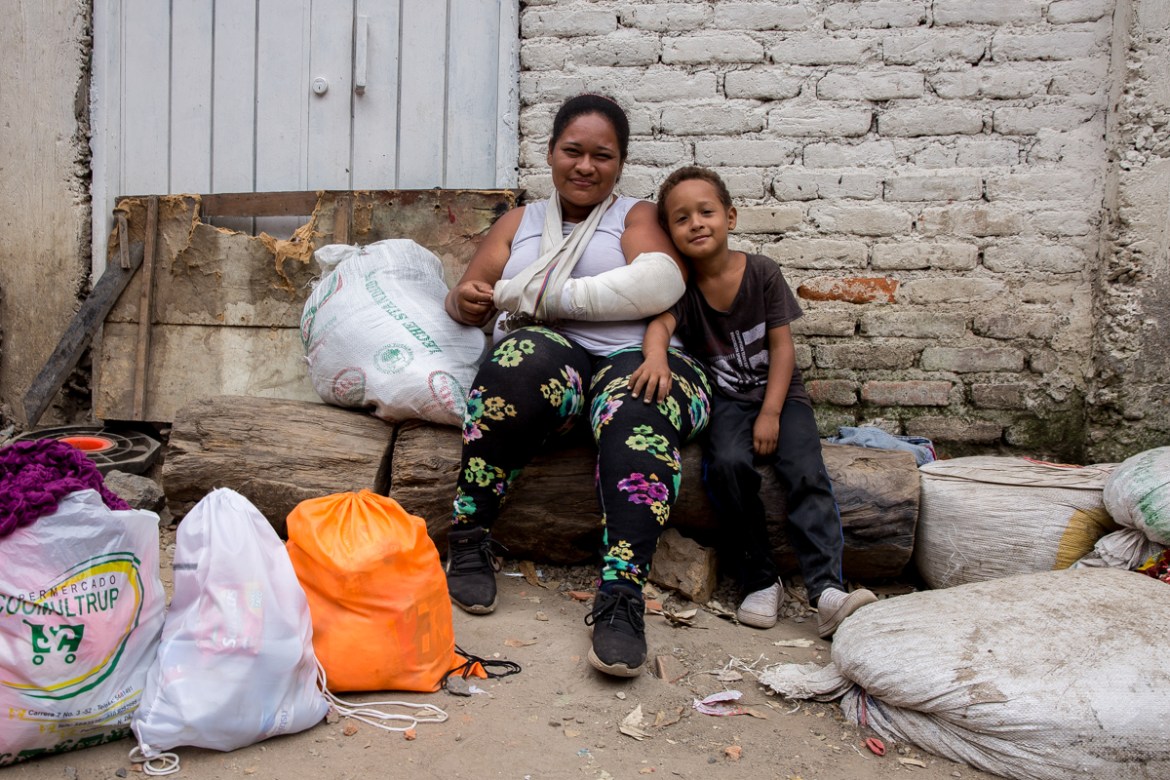 Diana Acosta, 32, sits with her 5-year-old son Dalied among a pile of bags that hold their things. She was working in a farm near the border city of Cu´cuta where she broke her arm working and her bos