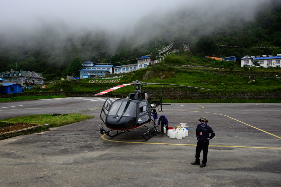 Captain Kiran Pun with his Eurocopter AS350, Lukla Airstrip - Kiran Pun has been flying Nepal’s mountain routes since 1995. “Some places you fly to all the time so you know what to expect,” he says. “